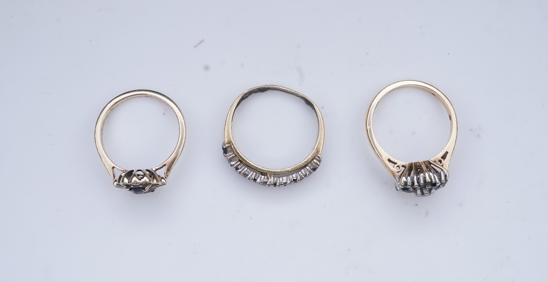 A collection of three sapphire and diamond rings